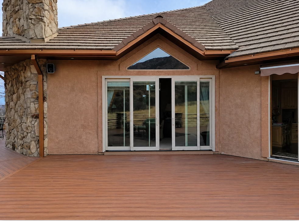 Wood deck with stucco wall and sliding glass doors